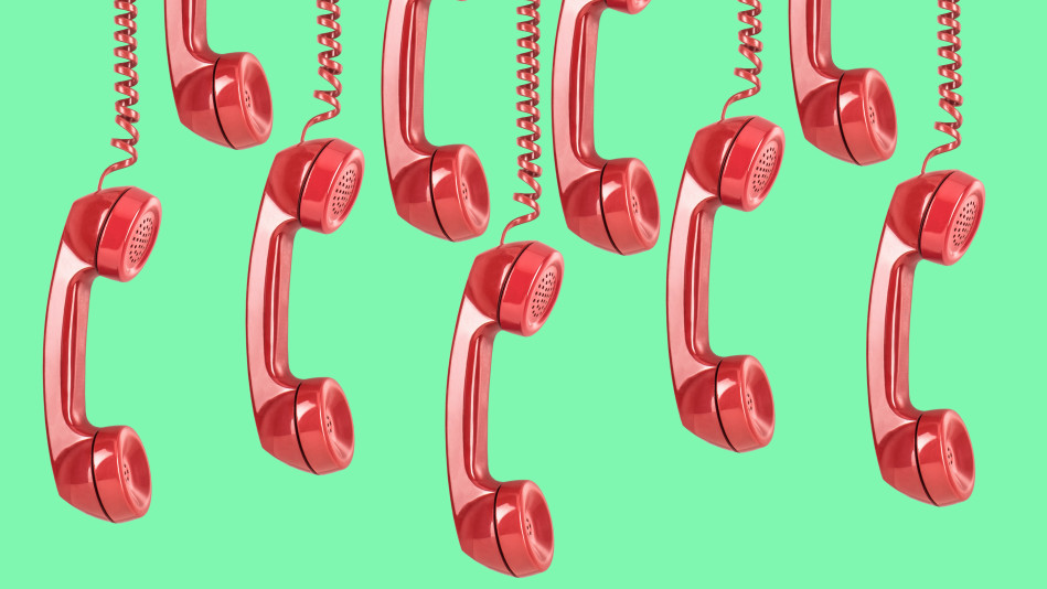 Red telephones on green background