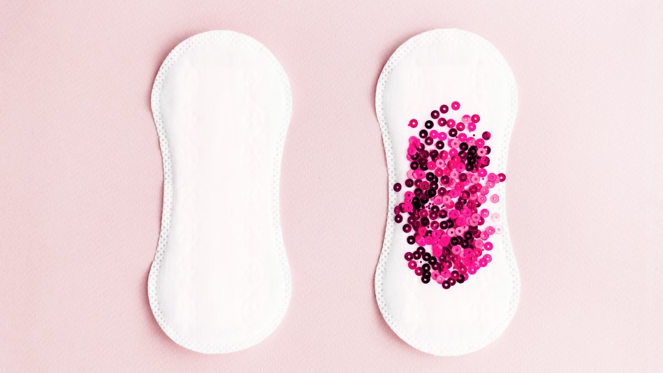 A menstrual pad covered in pink glitter