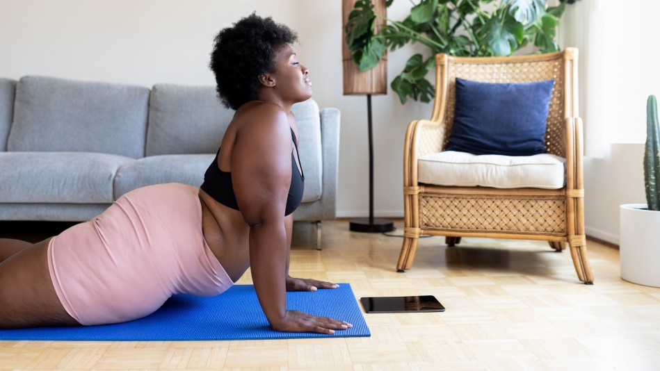 Black woman practicing yoga at home
