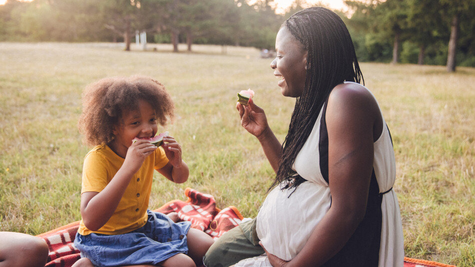 Pregnant Black mom picnicking with her daughter