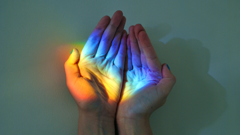 Rainbow light in cupped hands