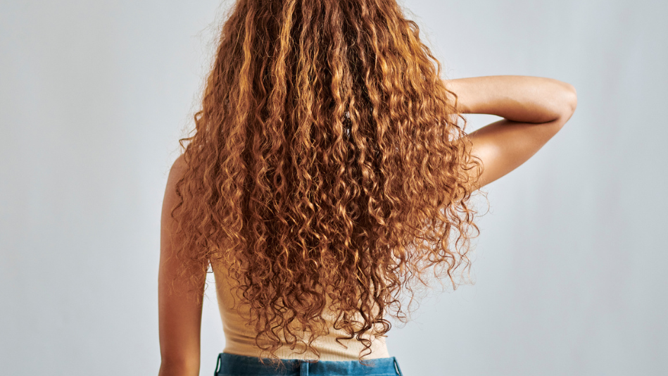 young woman with long, thick, curly hair