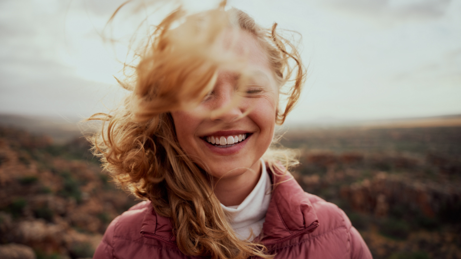 Carefree woman smiling on a windy day