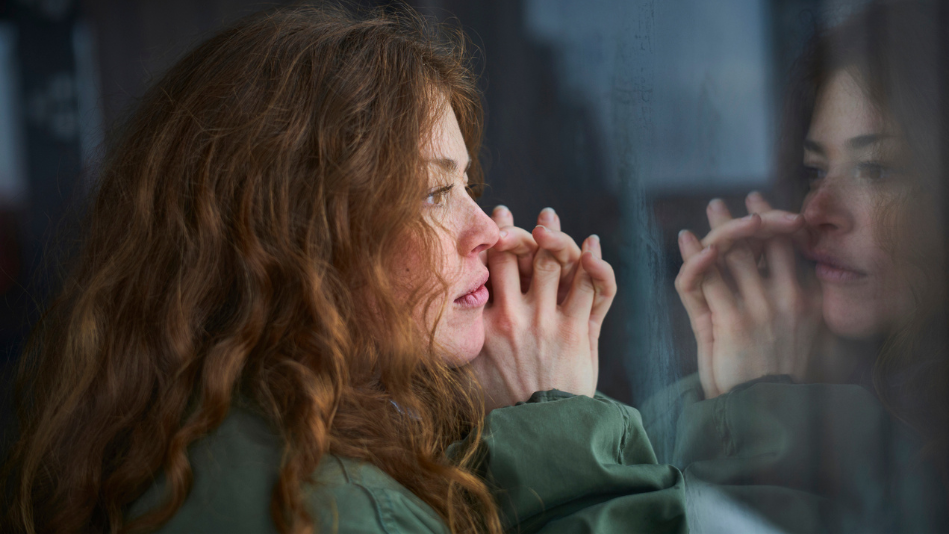 Woman looking contemplatively out her window