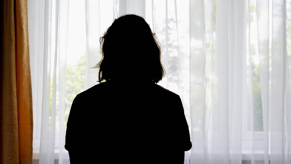 Silhouette of a woman in front of the window