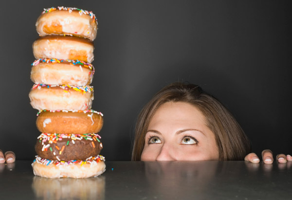 Woman eyeing doughnuts