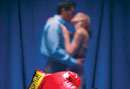 Boxing glove in front of kissing couple