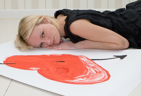 Woman laying on floor with heart
