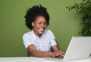 woman smiling with computer