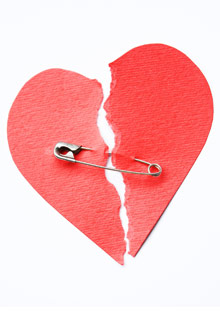 Paper broken heart with safety pin