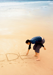 Woman writing in sand