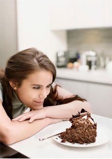 Woman staring at chocolate cake