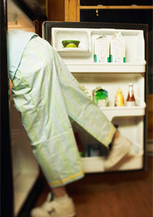 Person leaning into refrigerator