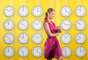 Woman checking her watch, surrounded by clocks