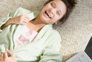girl laughing with laptop