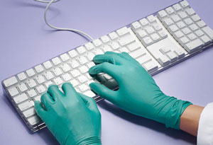 Gloved doctor hands typing