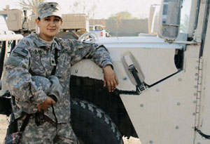 Victoria Olmo with a humvee in Camp Victory