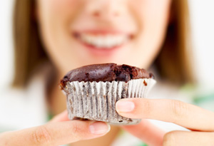 Girl eating a chocolate cupcake