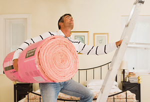 Man going into attic with insulation