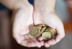 Child holding money out in hands