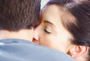 Woman kissing man's neck