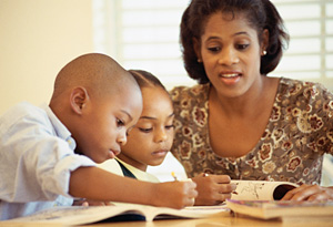 Mother helping children with homework