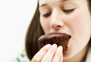 Teen girl eating muffin