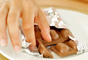 Woman grabbing chocolate