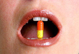 Pill in woman's mouth