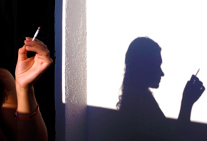 Silhouette of woman smoking