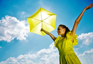 Happy woman with yellow umbrella